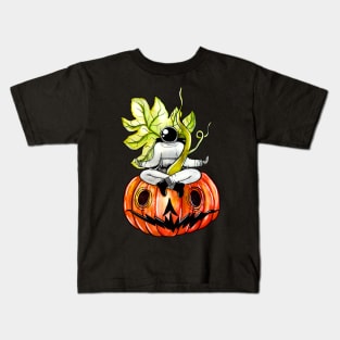 Astronaut meditating on a pumpkin Kids T-Shirt